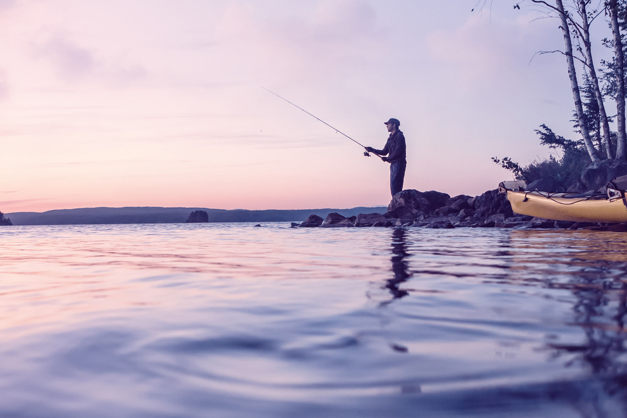 Man fishing at sunset.