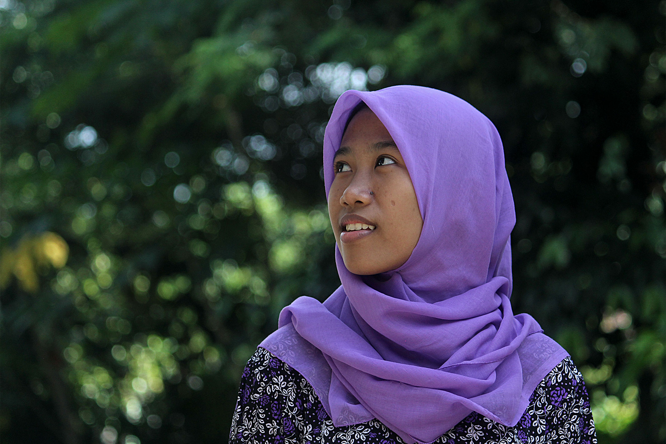 Young Indonesian woman looking hopeful